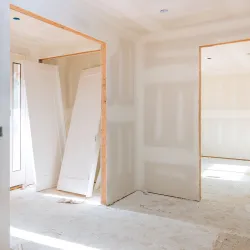 The interior of a home under construction with unfinished drywall