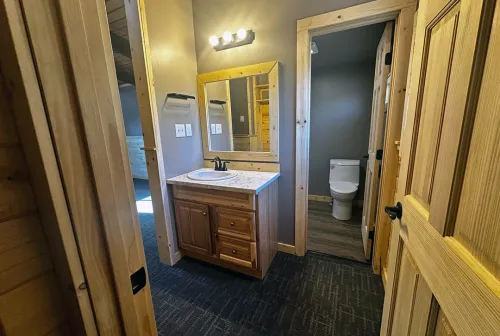 Campground bathroom facilities featuring dual vanity setup with wood cabinetry and efficient layout design, demonstrating True North Construction's attention to guest amenities and functionality